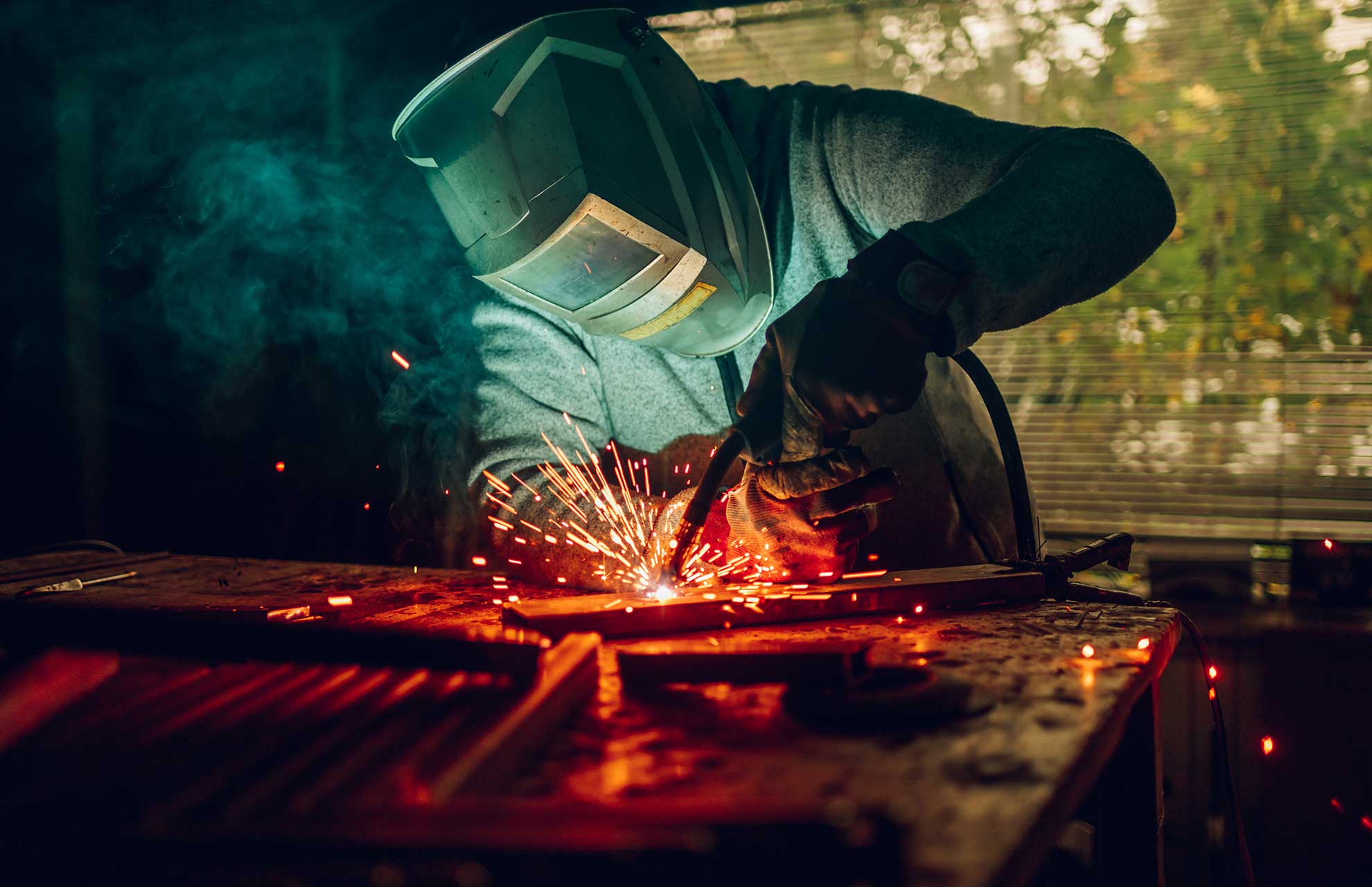 man-worker-welding-metal-with-welding-machine-in-a-3SG5PY4