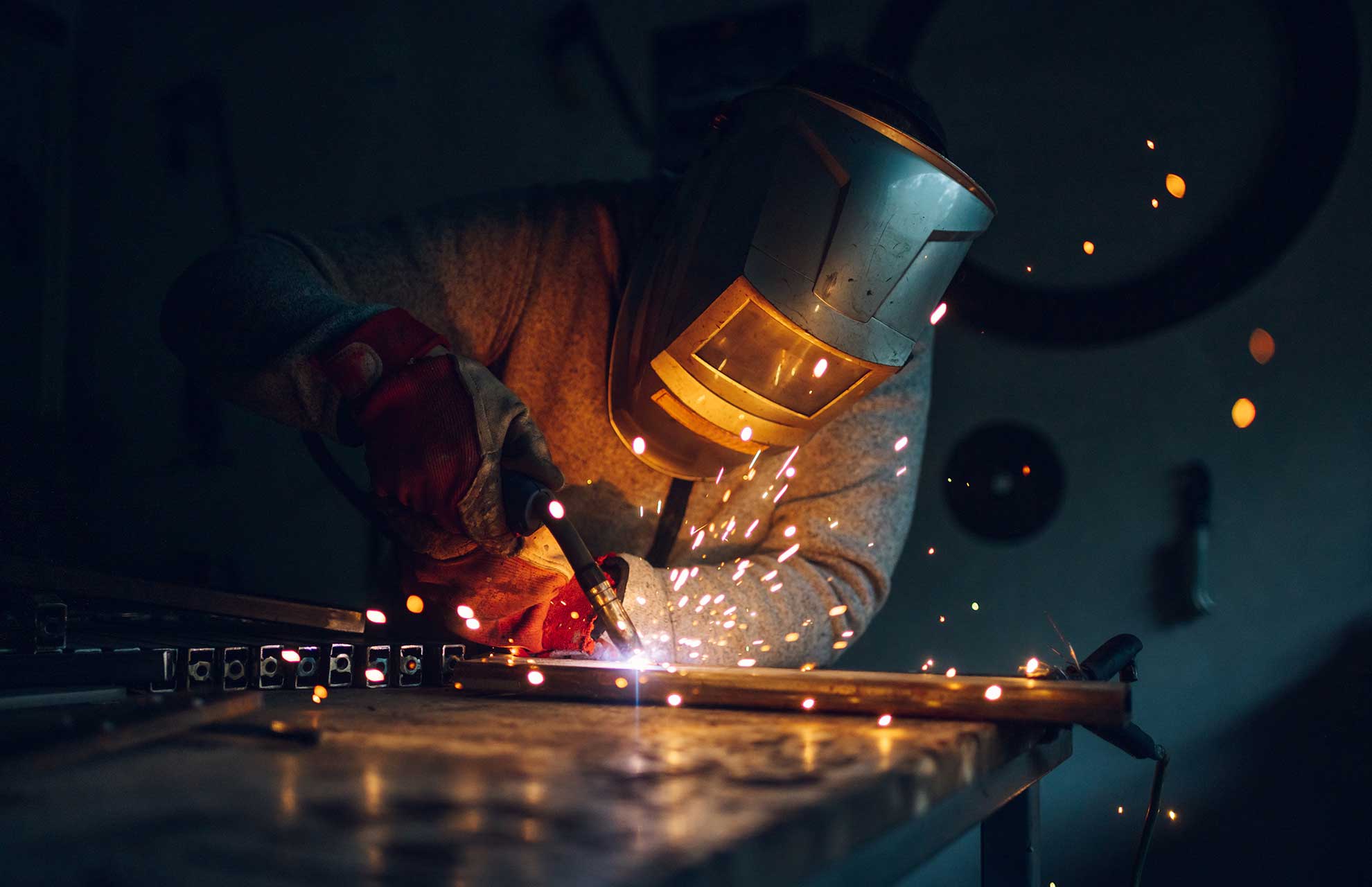 man-worker-welding-metal-with-welding-machine-in-a-6HBYM3R